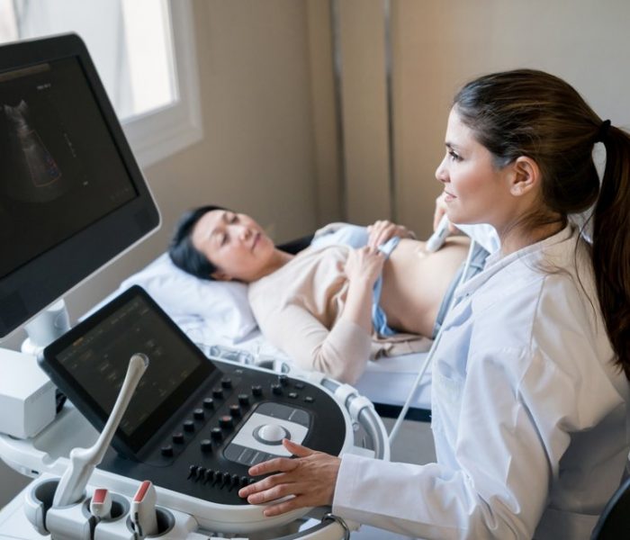 Doctor-doing-ultrasound-scan-on-asian-patient Doctor-doing-ultrasound-scan-on-asian-patient